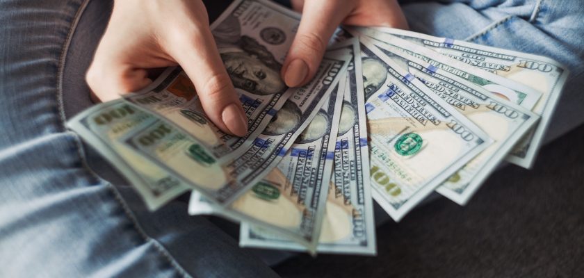 Girl holding American Dollar Bills