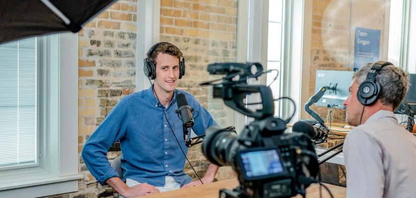 man being filmed on camera indoors