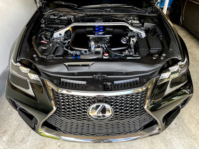 a-car-with-its-hood-open-in-a-garage